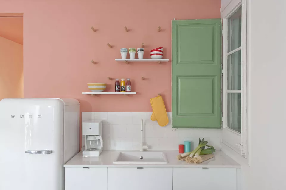 white kitchen with pink feature wall