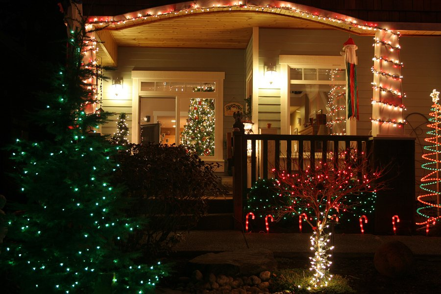 the front entry of a house lit up by Chrismas lights at night