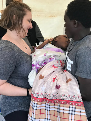 Haley DOlive carrying Janet to a Doctor at the Medical Clinic