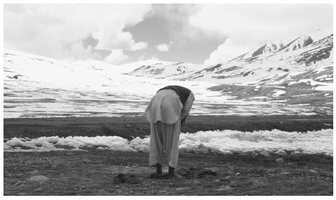 A muslim bows his head in prayer on the snow-capped mountain border of Pakistan, China, and Afghanistan. Both the Sunnis and the Shiites recognize the authority of the Koran and respect the five pillars of Islam.