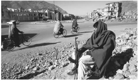 An Afghani man sits in the rubble of Kabul, Afghanistan in 1995. Between 1992 and 1995, the Taliban seized control of southern Afghanistan.