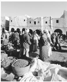 The center of Algerian commercial life is the souk , or open-air market. 