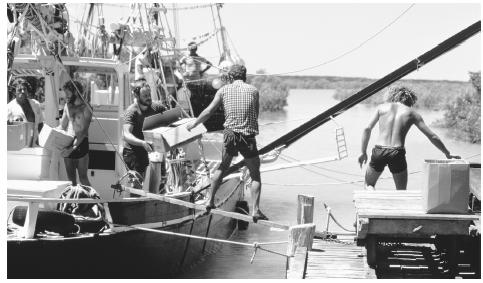 A traditional pearling lugger is loaded with supplies at Streeter's Jetty.