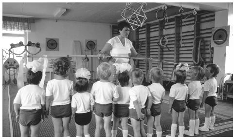 A teacher instructs students during a physical education class at their school in Minsk. The state controls child rearing and education.