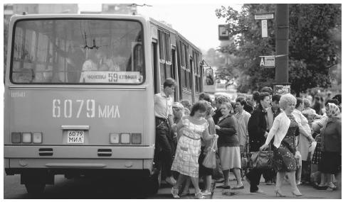 Commuters climb on and off a city bus in Minsk, the largest city, with a population of almost two million.