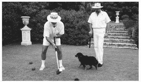 Two men playing croquet. Bermuda is an Overseas Territory of the British Crown.