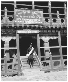 A government official walking out of an administrative building in Tongsa. Bhutan is a constitutional monarchy.