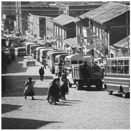 Buses and trucks line along the side of a cobbled street in the capital of La Paz. Since 1992 there has been increased migration from rural to urban areas.