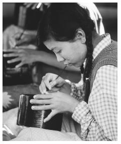 A Burmese woman at a lacquer factory.