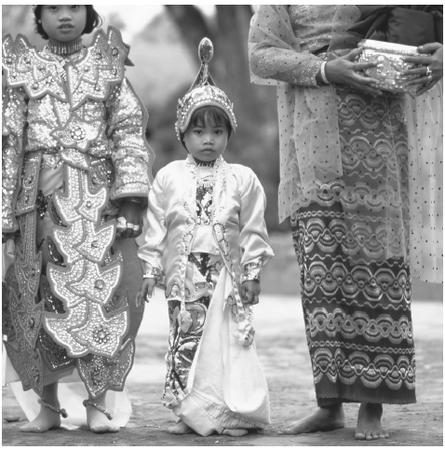 A young child at an initiation ceremony in Mandalay. Ninety percent of Burmese follow the Theravada form of Buddhism, also know as Hinayana Buddhism.