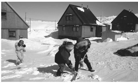 A group of children play hockey on the snow in Cape Dorset, Northwest Territories. Hockey, considered to be Canada's national sport, is popular across the nation.