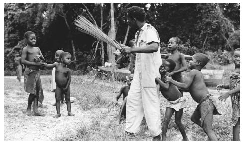 A group of children surround a boatman near Bangassou. Men constitute most of the employed workforce.