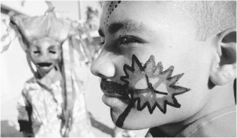 Children with painted faces and costumes participate in the Festival of Cabral, which takes place on Good Friday.