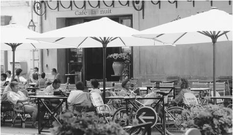 People at an outdoor café in France. Cafés are social centers for men in southern France and are also popular among tourists.