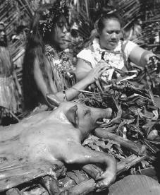 Roasting a pig at a festival in Atuona, Hiva Oa. Rural Polynesians provide much of their own food and generally cook only one meal each day.