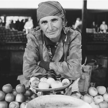 An apple seller in Tbilisi. A wide variety of fruits are grown in Georgia, although arable land is limited.