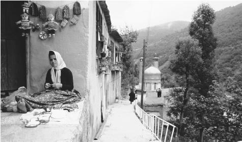 An Iranian woman sits on the ground while she makes knitted crafts in the Maseleh village located 1,050 meters above sea level in the Alborz Mountains.