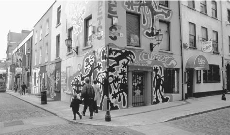 People walk past a colorful storefront in Dublin.