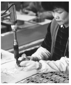 A woman working on a toy car. The toy industry plays a prominent role in Macau's economy.