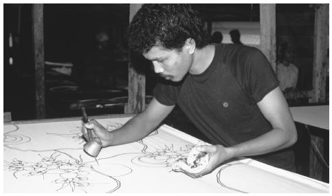 A textile worker creates a batik in Kota Bharu. Outside of northern peninsular Malaysia, batik designs are usually produced in factories.