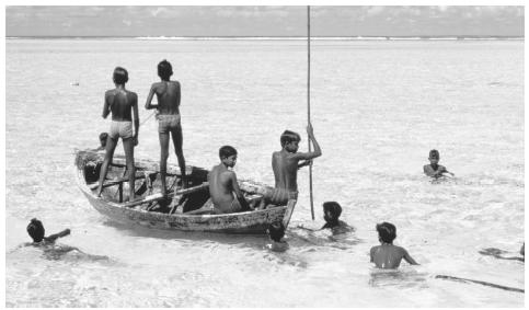 A group of boys fish in the shallow waters off the Maldives Islands. In addition to being an important food source, fish is the nation's greatest export.