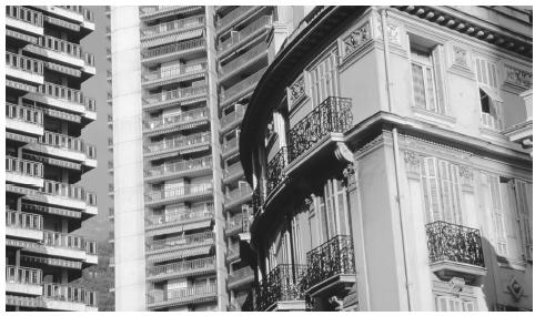 Contrasting old and modern architecture. The rocky, steep terrain of Monaco has influenced urban architecture; many buildings are constructed into the hills.