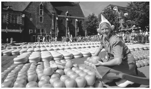 A woman selling cheese at the market in Alkmaar. The Netherlands has an advanced free market economy.