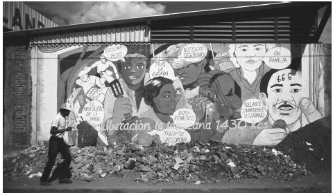 A man walks by a wall painted with political graffiti in Managua. The 1979 revolution of the Sandinistas was an attempt to eliminate the class system.