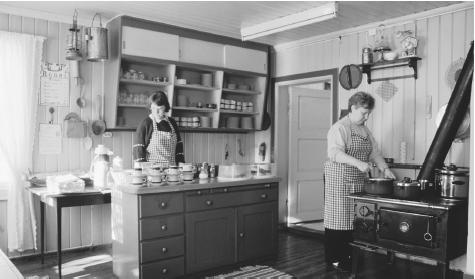 Women work in a Rabol, a traditional farm kitchen. Hafjell, Norway.