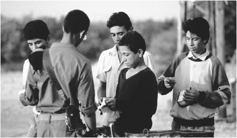 An official inspects magnetic identifications at the checkpoint between the Gaza Strip and Israel. Conflict between Israelis and Palestinians has resulted in decades of violence and created a need for tight security.