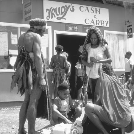 A group of people gather in front of a store in Mount Hagen.