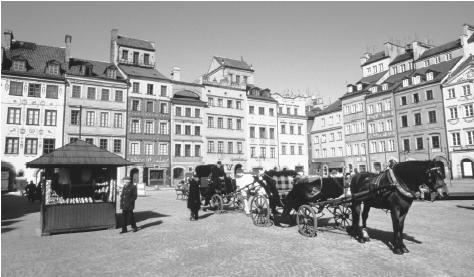 Horse-drawn carriages await passengers in a square in Old Town Warsaw. Warsaw has been Poland's capital since 1611, when it succeeded Cracow.