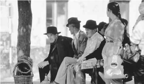 A group of people wait for a bus in Angro Do Heroismo. Urban Portuguese have a powerful sense of propriety about appropriate public dress.