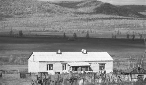 A house and the surrounding hills near Irkutsk, Siberia. The expense and lack of new housing has made for difficult living conditions in Russia.