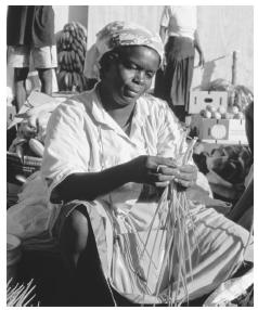 A market vendor examines onions in Castries. The market is regulated by the government.