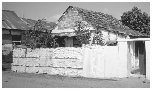 A house in Sokone, Senegal, has protected privacy with a painted metal fence.