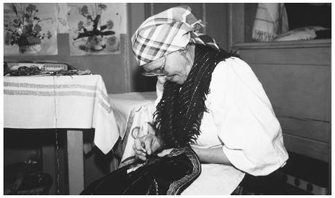 A Slovakian woman embroiders a piece of fabric. Slovakia has an extensive arts and crafts heritage.