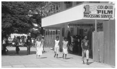 Residents of Honiara stroll on the street. As many as seventy distinct languages are spoken in the islands; one legacy of British colonizers is the use of English in formal places.