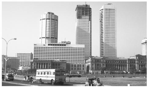 Modern office buildings often share space with older religious structures, forming a diverse architectural landscape in cities such as Colombo.