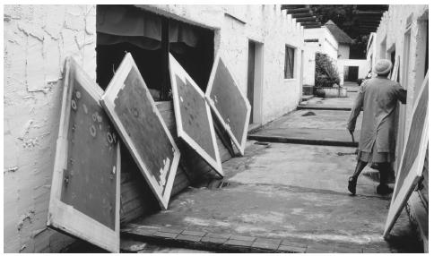 Silkscreens lean against the walls of a cloth-printing factory in Swaziland.