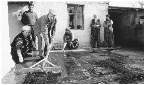 Workers from the Dobag Project wash a traditional hand-knotted carpet. Turkish carpets are prized for their quality and intricate design.