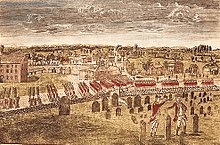 A birds-eye view of a long column of British soldiers marching by regiment along a road just outside of Boston