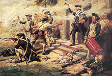 A close up of Continental infantry fighting in a street; a company on line firing to the left off the painting; in the center the officer; right foreground a drummer boy and behind him a soldier reloading a musket.