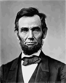 An iconic photograph of a bearded Abraham Lincoln showing his head and shoulders.