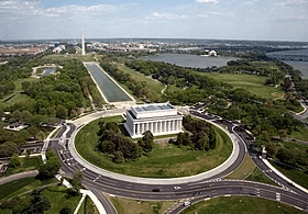 An aerial photo a large white building with big pillars.