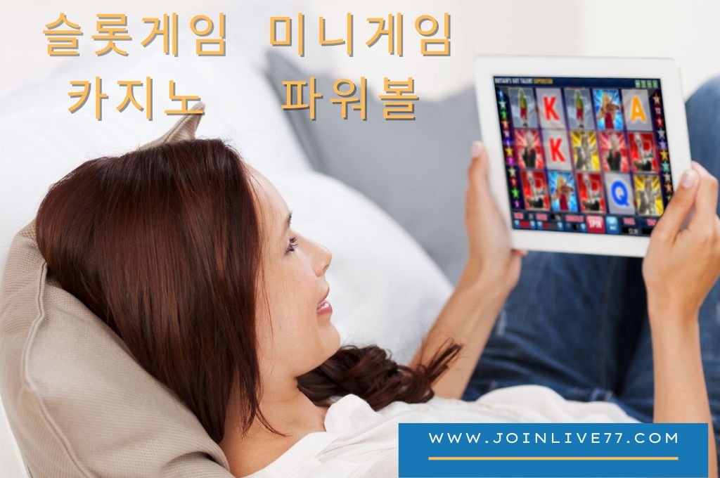 A girl lying on her bed, playing online bingo in the tablet