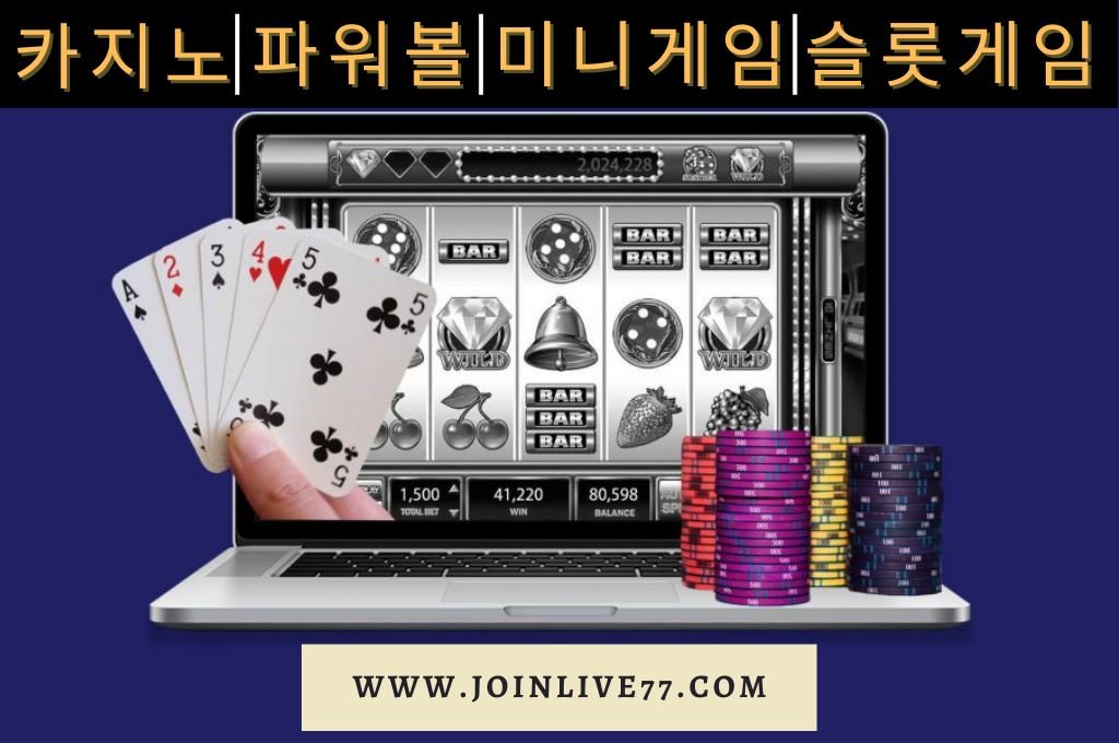 Black and white laptop with casino chips and cards.