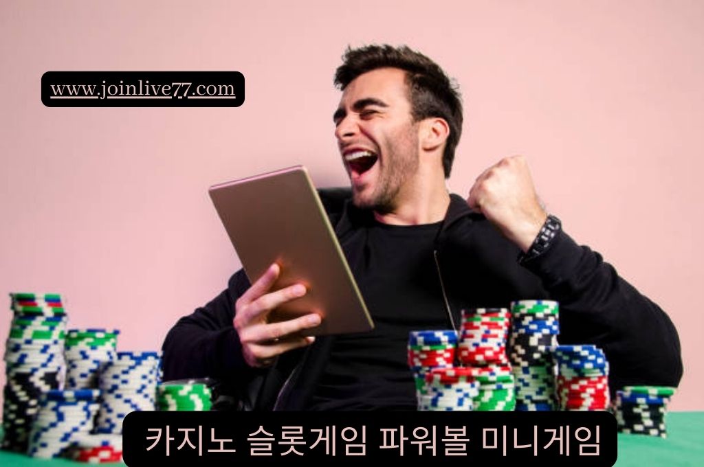 Man looking happy holding his tablet and a lot of casino chips on the table