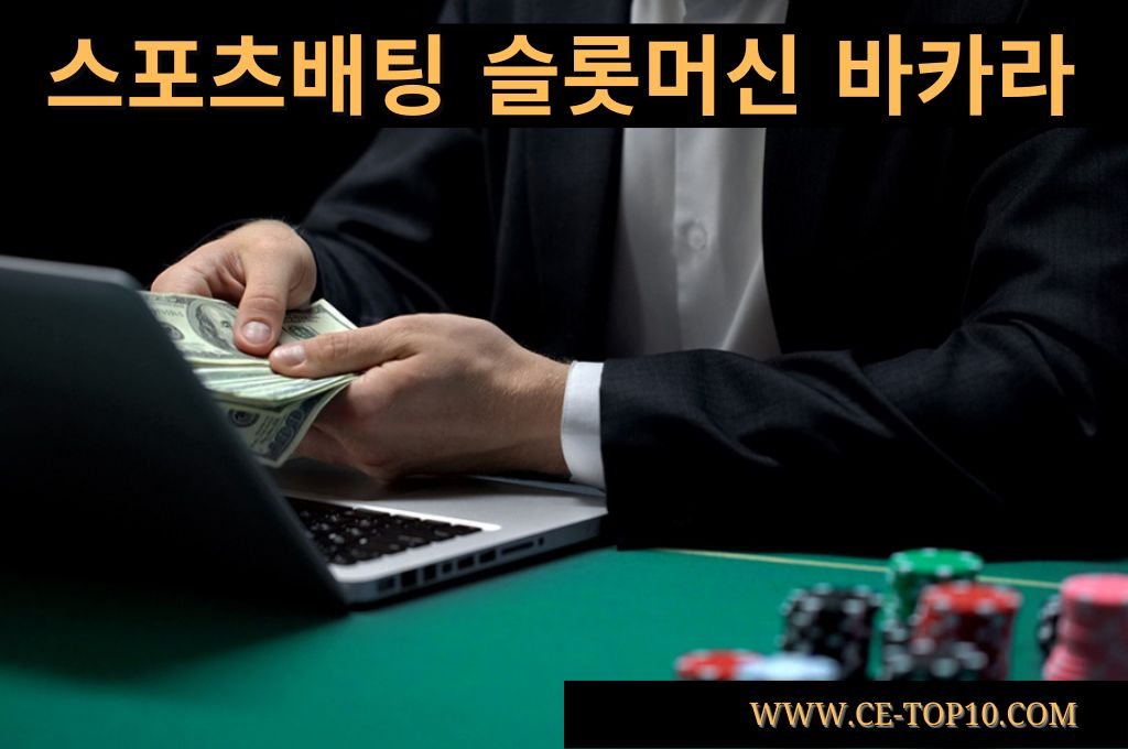Man in suit counting cash bills in front of green table with laptop and poker chips.