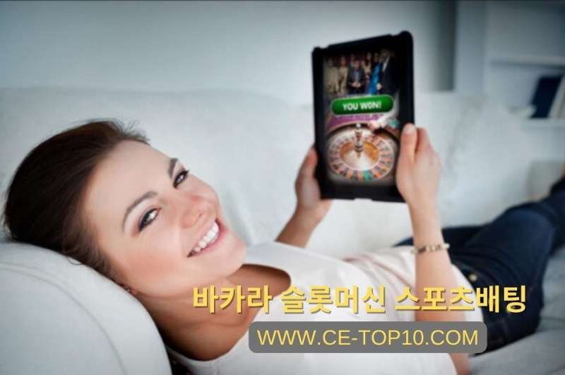 A girl lying on the couch while playing online casino on her tablet